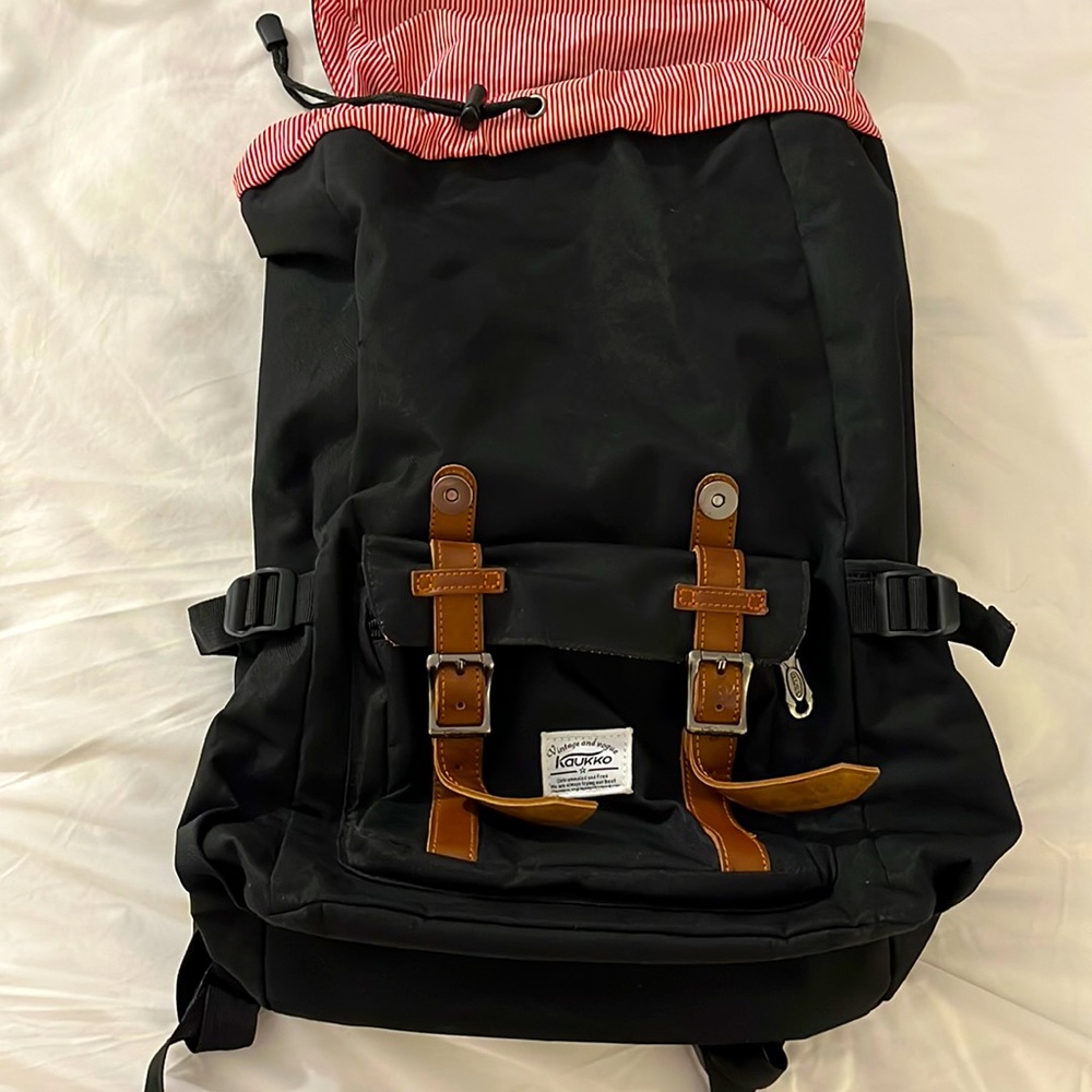 Black backpack with red/white stripes on inside